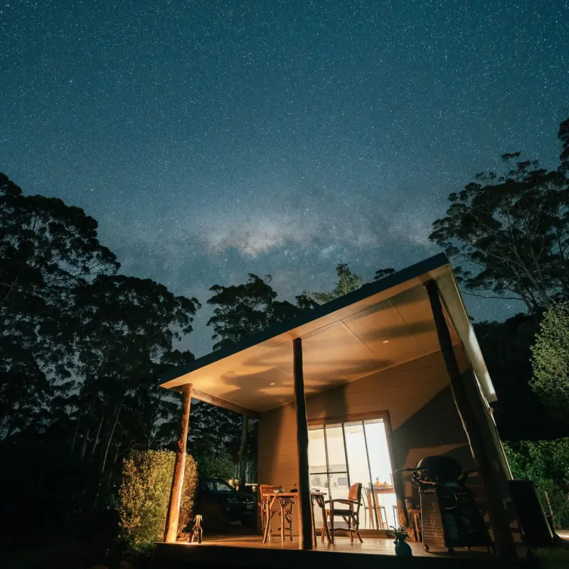 Karri chalet at night underneath stars