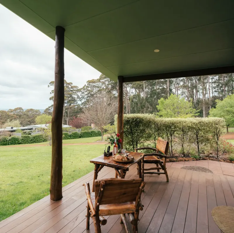 The Karri chalet balcony with two chairs and a table
